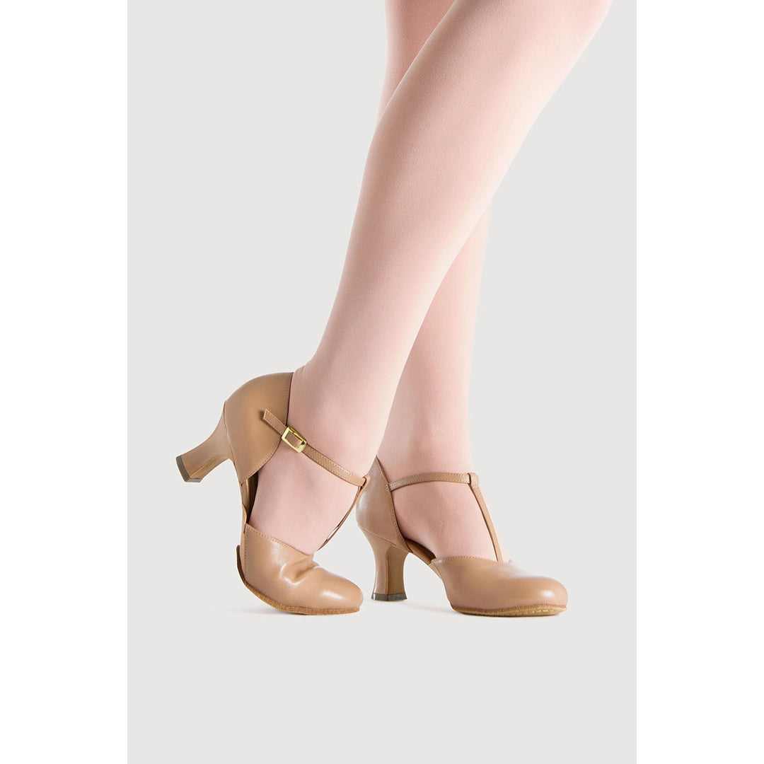 Beige Mary Jane high heels with ankle straps and T-strap details, shown on a model&