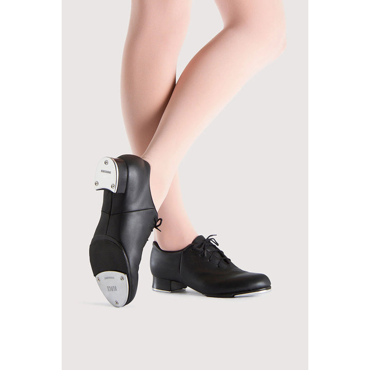 Black leather dance shoes with metal tap heels, shown on a model&