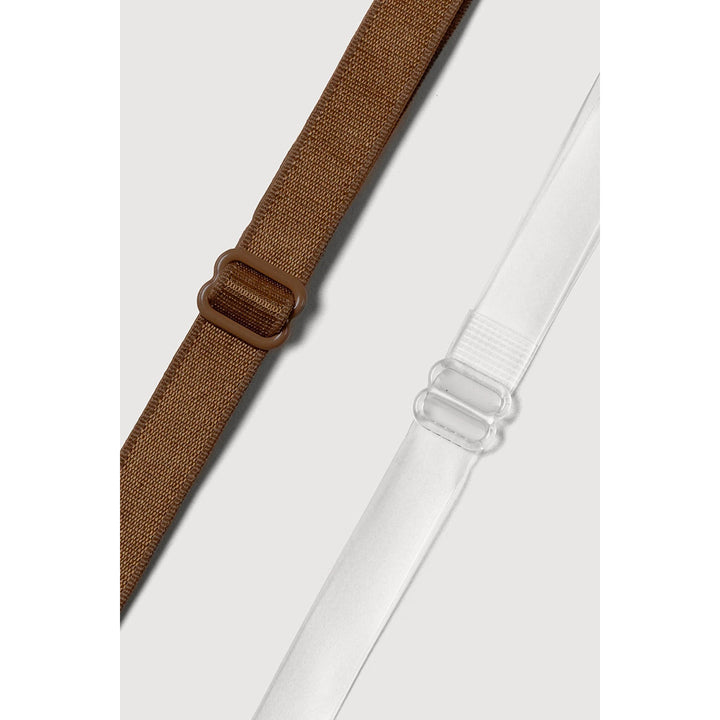 Two adjustable bra straps suspenders laid diagonally on a light gray background: one brown woven strap with a brown plastic buckle, and one white elastic strap with a clear plastic buckle.