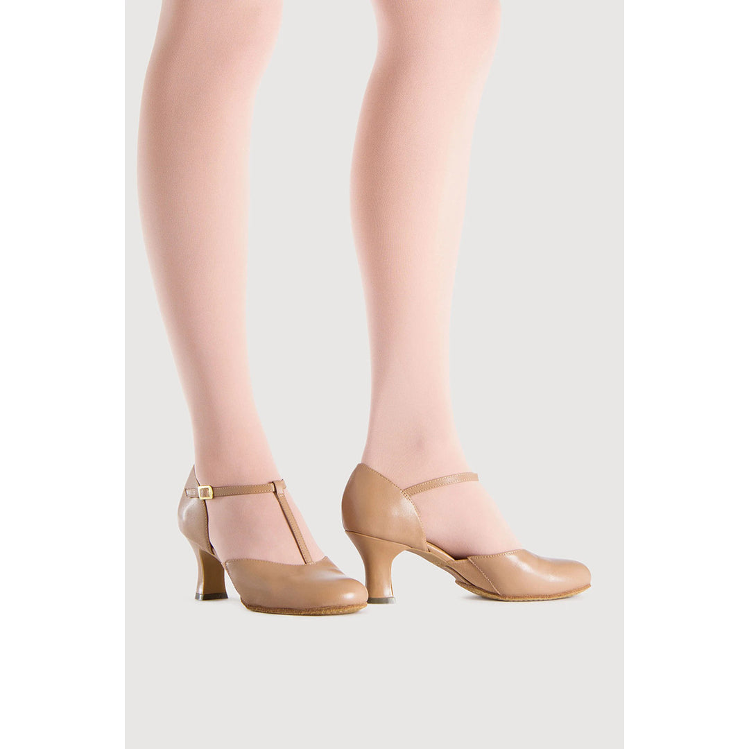 Beige leather T-strap heels with kitten heels, shown on a model&