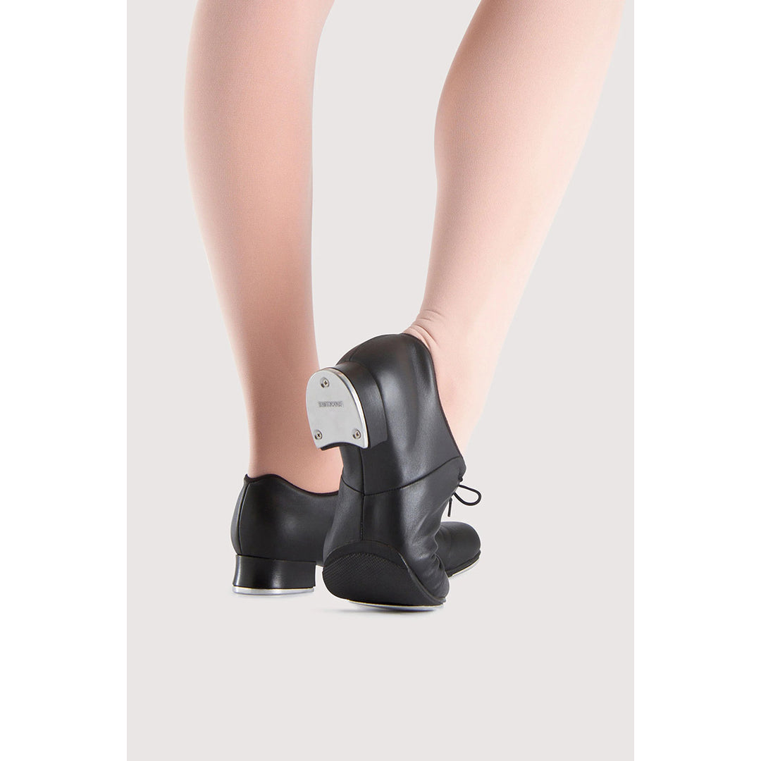 Black leather dance shoes with metal ball joints, shown on a model&